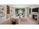 Cozy living room with a fireplace, large windows with backyard views, and stylish furniture at 332 S Franklin St, Denver, CO 80209