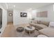 Bright living room featuring a comfortable beige sectional sofa, modern decor, and wood flooring at 332 S Franklin St, Denver, CO 80209