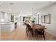 Open-concept living area showcasing a dining table, modern lighting, and access to the living room and kitchen at 332 S Franklin St, Denver, CO 80209