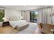 Bright main bedroom with sleek hardwood floors, a sitting area, and a glass door to the balcony at 332 S Franklin St, Denver, CO 80209