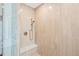 Modern shower with beige tiled walls, a built-in bench, and a sleek shower head at 332 S Franklin St, Denver, CO 80209