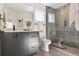 Modern bathroom with gray tile, walk-in shower, and floating vanity at 1248 N Tennyson St, Denver, CO 80204