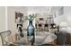 Bright dining area with glass table and modern chairs, open to kitchen at 1248 N Tennyson St, Denver, CO 80204