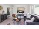 Relaxing living room with dark sofa, accent chair and natural light at 1248 N Tennyson St, Denver, CO 80204