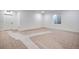 Unfinished basement space featuring neutral carpeting, a window, and a white door at 17822 E 107Th Pl, Commerce City, CO 80022