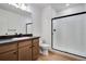 Stylish bathroom with a glass-enclosed shower and dark countertops at 17822 E 107Th Pl, Commerce City, CO 80022
