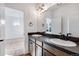 Bathroom features a double sink vanity with modern fixtures and sleek countertops, offering ample space and style at 17822 E 107Th Pl, Commerce City, CO 80022