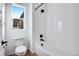 Clean white bathroom features a bathtub with white subway tile and modern black fixtures at 17822 E 107Th Pl, Commerce City, CO 80022
