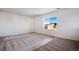 Bedroom with neutral carpet, white walls, and a large window at 17822 E 107Th Pl, Commerce City, CO 80022