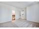 Bright bedroom with neutral carpet features white walls and two interior doors at 17822 E 107Th Pl, Commerce City, CO 80022