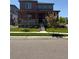 Charming two-story home featuring a covered front porch and well-manicured lawn at 17822 E 107Th Pl, Commerce City, CO 80022