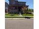 Charming two-story home featuring a covered front porch and well-manicured lawn at 17822 E 107Th Pl, Commerce City, CO 80022