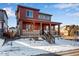 Attractive two-story house with a covered porch and well-kept landscaping, all set against a clear, sunny sky at 17822 E 107Th Pl, Commerce City, CO 80022