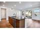 Modern kitchen island with sleek countertops and stainless steel appliances and wood floors at 17822 E 107Th Pl, Commerce City, CO 80022