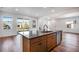 Kitchen island with a stainless steel dishwasher overlooking the patio and the rest of the house at 17822 E 107Th Pl, Commerce City, CO 80022