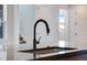 Close up of kitchen island featuring modern faucet, single basin sink, and quartz countertop at 17822 E 107Th Pl, Commerce City, CO 80022