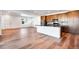Modern kitchen with an island, wood cabinets, stainless appliances, and light hardwood floors at 17822 E 107Th Pl, Commerce City, CO 80022