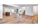 Spacious living room with hardwood floors, an open layout, and modern staircase access at 17822 E 107Th Pl, Commerce City, CO 80022