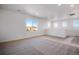 Bright living room featuring neutral carpet, white walls, and natural light at 17822 E 107Th Pl, Commerce City, CO 80022