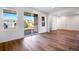 Bright living room with hardwood floors, large windows, and sliding glass doors leading to the patio at 17822 E 107Th Pl, Commerce City, CO 80022