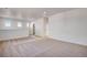 Spacious living room with neutral carpet, white walls, and natural light at 17822 E 107Th Pl, Commerce City, CO 80022