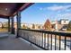 Relaxing porch view with a sturdy railing, overlooking a peaceful neighborhood on a bright, sunny day at 17822 E 107Th Pl, Commerce City, CO 80022