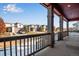 Inviting porch with sturdy columns and railings, offering a pleasant neighborhood view on a sunny day at 17822 E 107Th Pl, Commerce City, CO 80022