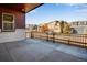 Expansive patio area surrounded by a black iron fence, offering picturesque neighborhood views and ample space for outdoor activities at 17822 E 107Th Pl, Commerce City, CO 80022