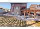 Landscaped backyard featuring a multi-level deck, pergola, and outdoor seating area at 10265 Olathe St, Commerce City, CO 80022