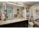 This bathroom features a modern vanity with a large mirror and Paris themed shower curtain at 10265 Olathe St, Commerce City, CO 80022