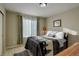 Cozy bedroom with a large window, soft green curtains, and comfortable decor at 10265 Olathe St, Commerce City, CO 80022