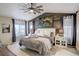 Cozy bedroom featuring wood paneled wall, plush bedding, and soft lighting at 10265 Olathe St, Commerce City, CO 80022