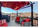 Relaxing deck area with overhead awning, comfortable seating, grill, and neighborhood views at 10265 Olathe St, Commerce City, CO 80022