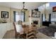 Dining room featuring wood table, cozy fireplace, and ample natural light at 10265 Olathe St, Commerce City, CO 80022