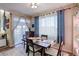 Dining area featuring elegant curtains and views of the outdoor living space at 10265 Olathe St, Commerce City, CO 80022