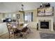 Dining room featuring a rustic wooden table set and cozy fireplace at 10265 Olathe St, Commerce City, CO 80022