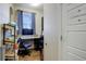 Home office with desk, hardwood floors, natural light, and a 'Bathroom' door sign at 10265 Olathe St, Commerce City, CO 80022