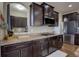 Well-lit kitchen with granite countertops, stainless steel appliances, and dark wood cabinetry at 10265 Olathe St, Commerce City, CO 80022