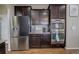 Kitchen featuring stainless steel appliances and dark cabinetry and hardwood floors at 10265 Olathe St, Commerce City, CO 80022