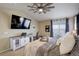 Serene main bedroom with tray, white storage cabinet, and light-filled window with sheer curtains at 10265 Olathe St, Commerce City, CO 80022