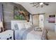 Comfortable main bedroom with wood accent wall and sliding barn door leading to ensuite bathroom at 10265 Olathe St, Commerce City, CO 80022