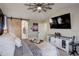 Bright main bedroom featuring ensuite bathroom with sliding barn door and modern ceiling fan at 10265 Olathe St, Commerce City, CO 80022