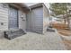 Corner view of back entrance featuring dark door, steps, and low maintenance gravel landscaping at 921 Meade St, Denver, CO 80204