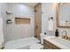 Tastefully designed bathroom featuring a tub, tile, and a modern sink with gold fixtures at 921 Meade St, Denver, CO 80204