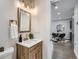 Bathroom featuring a stylish wood vanity, modern fixtures, and a decorative mirror for a contemporary touch at 921 Meade St, Denver, CO 80204