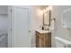 Well-lit bathroom with modern vanity, gold fixtures, and a door to the bedroom area at 921 Meade St, Denver, CO 80204