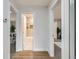 Hallway view of bathroom and living room with hard wood floors and white trim at 921 Meade St, Denver, CO 80204