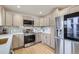 Modern kitchen featuring light wood cabinets, stainless steel appliances and quartz countertops with designer backsplash at 921 Meade St, Denver, CO 80204