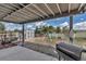 Covered patio with grill, shed, chicken coop, and ' play area, perfect for outdoor enjoyment and activities at 2996 Savage Rd, Elizabeth, CO 80107