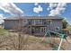 Spacious backyard featuring a deck, patio, play set, and white picket fence, perfect for outdoor activities at 2996 Savage Rd, Elizabeth, CO 80107